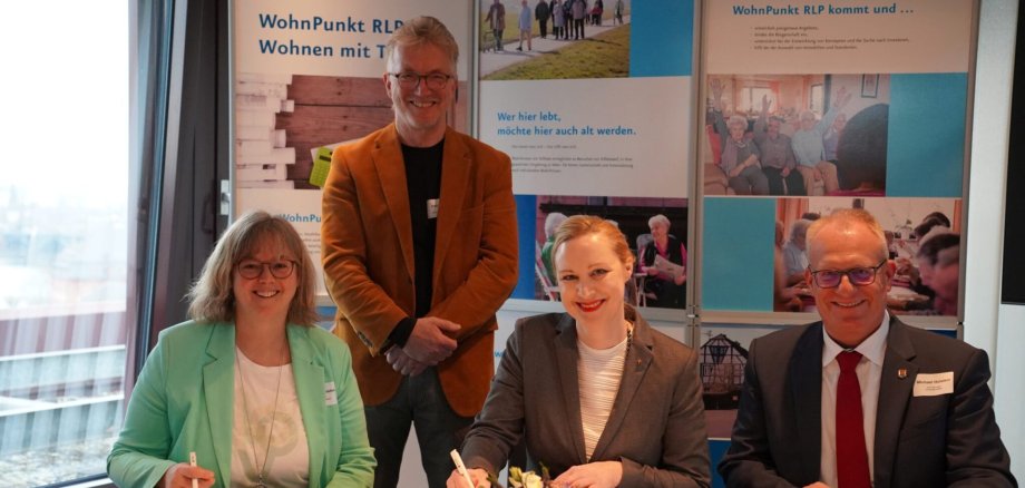 Ortsbürgermeisterin Claudia Thielen (l.) und Sozialministerin Dörte Schall unterzeichnen im Beisein von Bürgermeister Michael Holstein und Ralf Kierspel (2.v.l.), Erster Beigeordneter der Ortsgemeinde Aach die Kooperationsvereinbarung. Foto: Ministerium für Arbeit, Soziales, Transformation & Digitalisierung MASTD